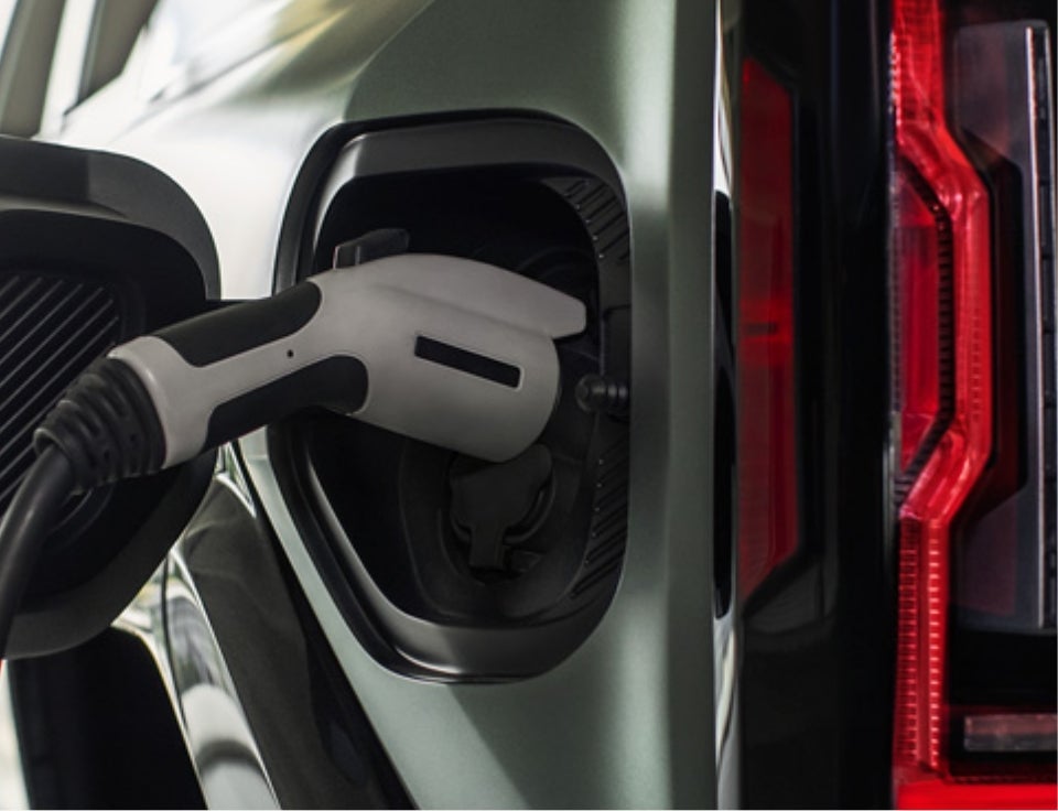 Close up of charging port with charger plugged in on a GMC Hummer EV SUV - Wuerflein GMC in Albert Lea MN